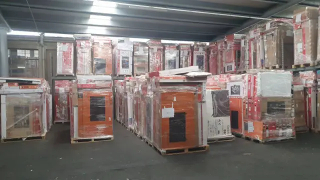Rows of liquidation pallets inside the Houston warehouse